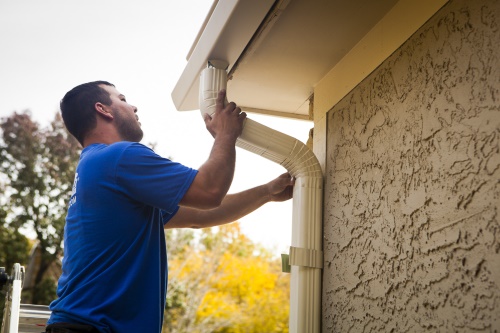 K-Guard Technician Installing Downspouts - K-Guard Heartland