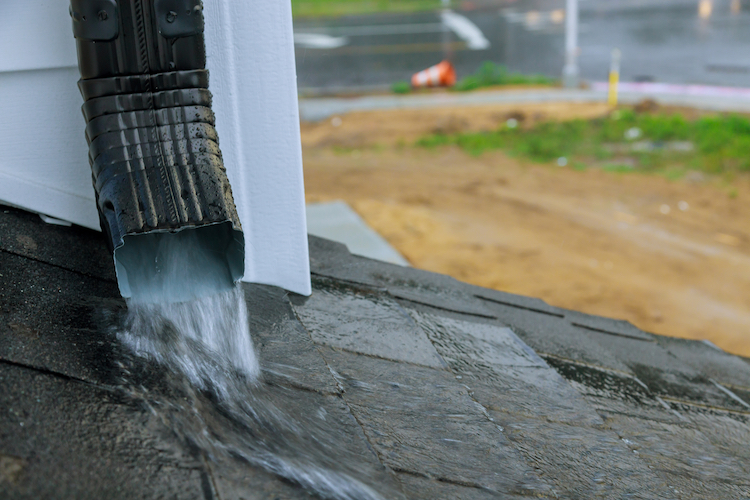Close-up off Downspout During Heavy Rainfall - K-Guard Heartland