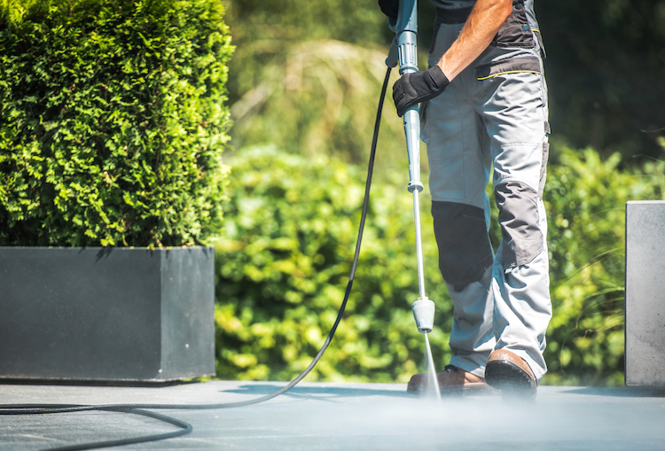 Man Pressure Washing the Ground - K-Guard Heartland