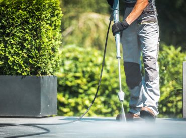 Man Pressure Washing the Ground - K-Guard Heartland