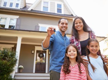 Family Portrait in Front of New Home Holding Keys - K-Guard Heartland