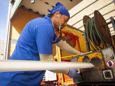 Technician Shaping a Seamless Aluminum K-Guard Gutter Cover - K-Guard Heartland