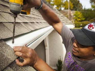 Man Installing Seamless Gutters on a House- K-Guard Heartland