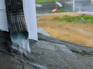 Close-up off Downspout During Heavy Rainfall - K-Guard Heartland