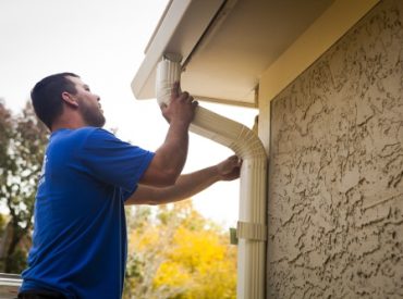 K-Guard Technician Installing Downspouts - K-Guard Heartland