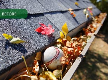 Rain gutter full of autumn leaves with a baseball - K-Guard Heartland