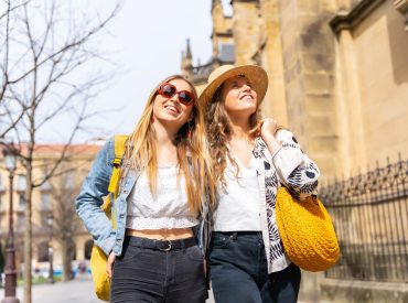 Lifestyle of tourist friends on vacation in the city smiling, enjoying the spring days off in the city of San Sebastian on a spring morning, Gipuzkoa
