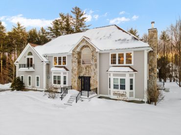 A,Modern,Two-story,House,On,Snowy,Winter,Landscapewith,Trees,In